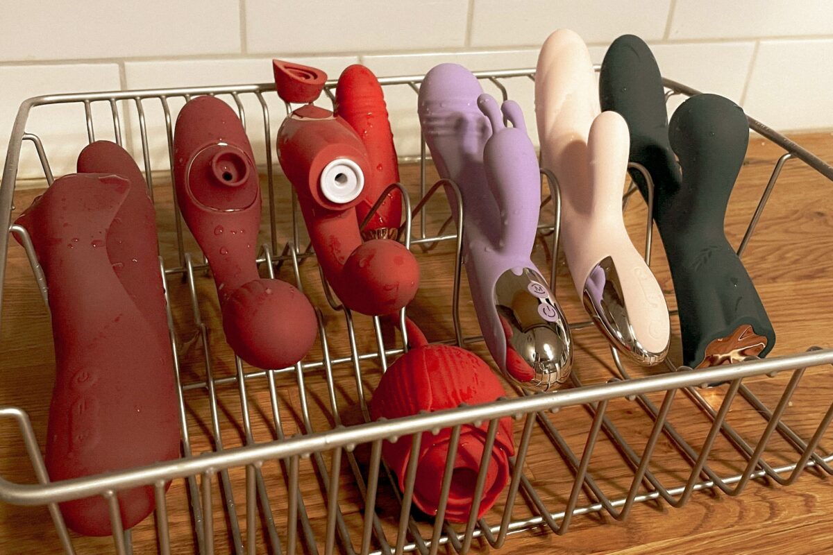 Jouets sexuels variés qui sèchent sur un égouttoir à vaisselle.